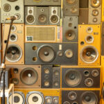 High stack of speakers with a microphone in a small space