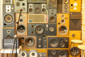 High stack of speakers with a microphone in a small space