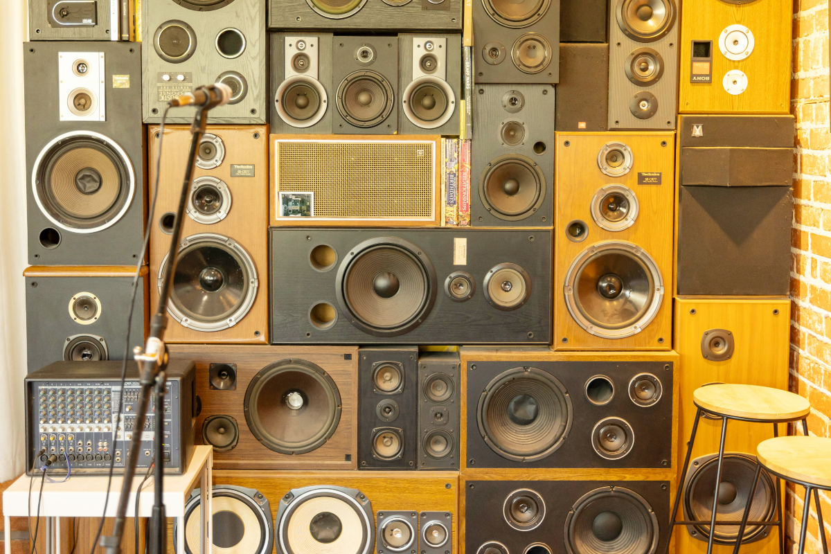 High stack of speakers with a microphone in a small space